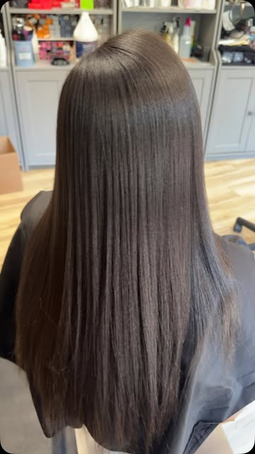 Long, sleek, smooth dark hair after a straightening service by Crystal Phung at Salon Bravissimo