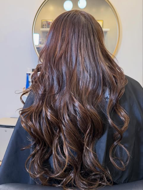 Long brunette hair with soft waves after I-Tip hair extensions by Joy Ho at Salon Bravissimo