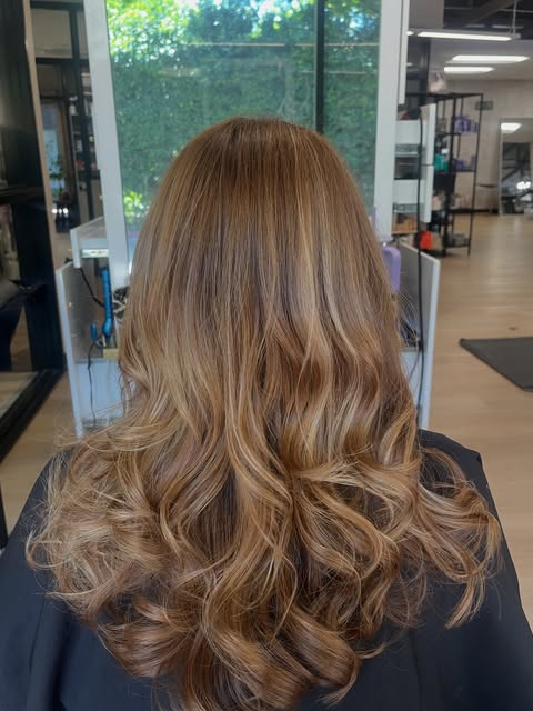 Soft caramel brown waves in long hair by Lilit Avetisyan at Salon Bravissimo