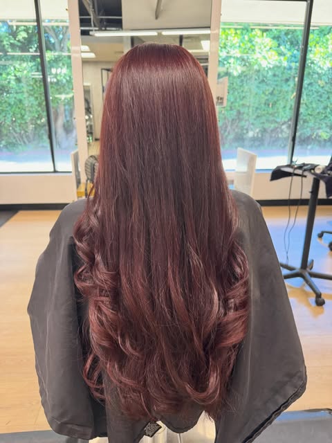 Long burgundy red hair with soft curled ends
