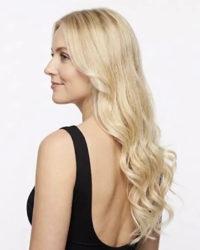 Side view of long, full, wavy blonde hair created with hair extensions