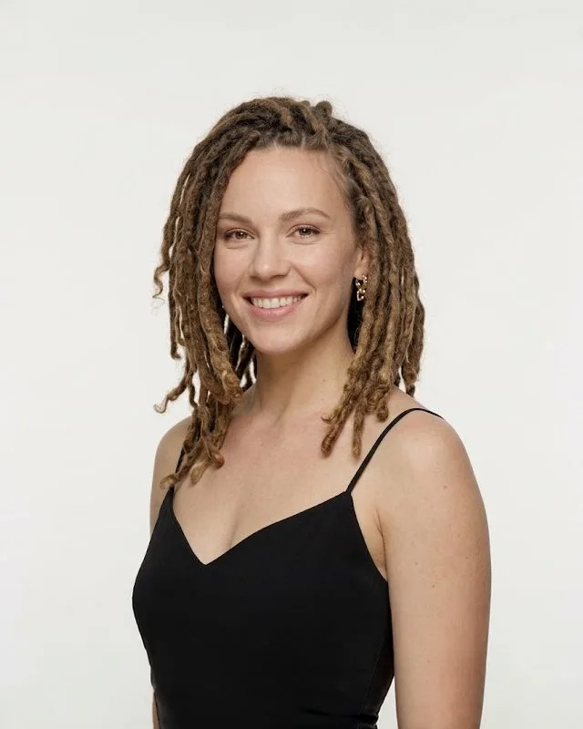 Smiling woman with long honey-blonde locs, loc services at Salon Bravissimo in Sacramento and Folsom