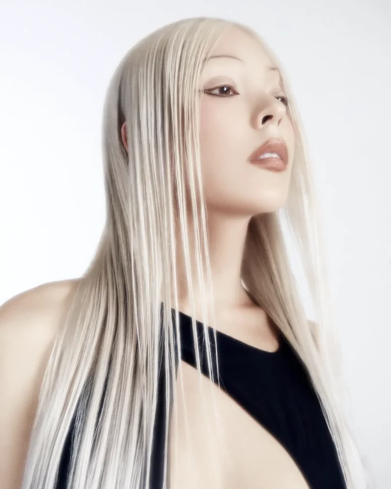 Model with long, sleek, smooth platinum blonde hair after an SB Custom Smooth Treatment